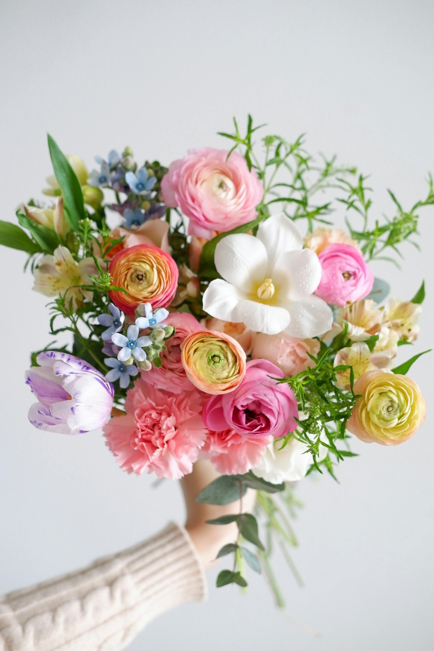 A Flower Designer at Clayton Florist Holding A Fresh Bouquet 